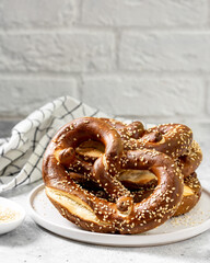 German pretzel. Pretzels with sesame seeds on the light gray kitchen table