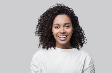 Beautiful young happy woman closeup studio portrait, Smiling cute joyful student girl isolated on gray background