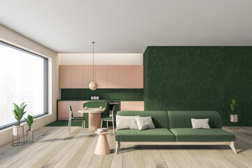 Living room interior with green furniture and windows
