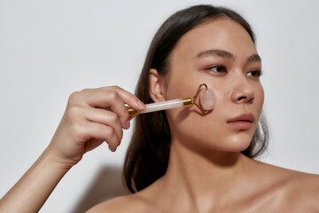 Girl in the studio with a roller for leather