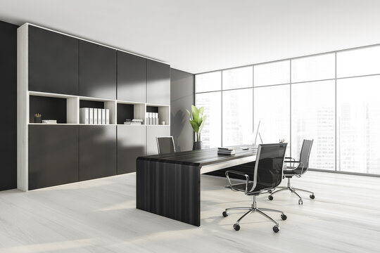 Black and white consulting room with furniture and windows