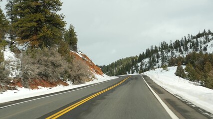 Road trip in USA from Zion to Bryce Canyon, driving auto in Utah. Hitchhiking traveling in America, Route 89 to Dixie Forest. Winter local journey, calm atmosphere and snow mountains. View from car.