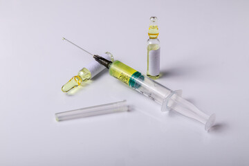 syringe and vials of medicine ready for injection on a white background