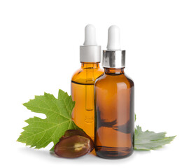 Bottles of grape seed oil on white background