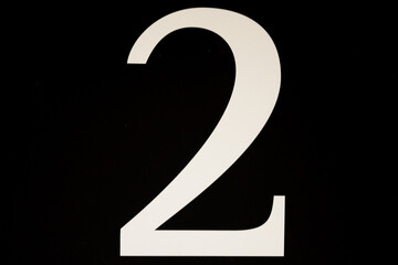 High contrast black and white sign with the number two - 2