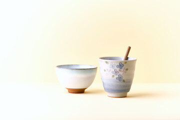 Traditional, handcrafted ceramic on yellow background. Soft focus. Copy space.