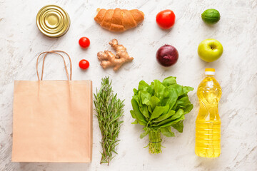 Paper bag with different products on light background