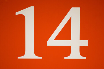 Colorful red and white sign with the number .fourteen - 14