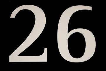 High contrast black and white sign with the number twenty-six - 26