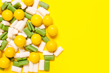 Tasty chewing gums on color background
