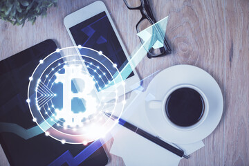 Double exposure of blockchain theme hologram over table with phone. Top view. Crypto technology...