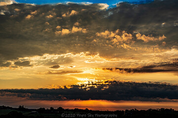 Rural landscape with clouds at sunset 