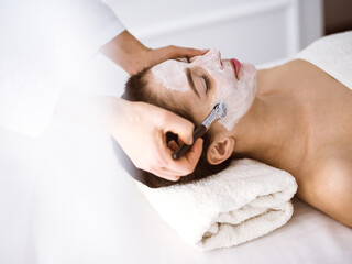 Obraz na płótnie Canvas Beautiful brunette woman enjoying applying cosmetic mask comfortable and bissfulle. Relaxing treatment in medicine and spa center concepts