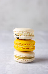 Colorful French macarons stack on the table.