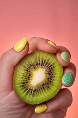 hand holding kiwi fruit