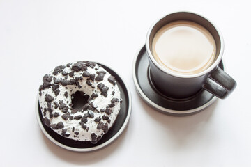 honey dipped donuts on a black plate with a black coffee cup isolated on white