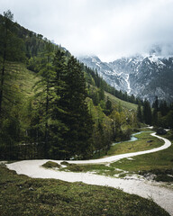 Obraz premium Alpine Road at Berchtesgaden with clouds on the sky and dust