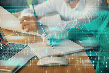 Double exposure of forex chart drawing over people taking notes background. Concept of financial analysis