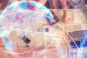 Naklejka premium Double exposure of man and woman working together and financial chart hologram drawing. market analysis concept. Computer background. Top View.