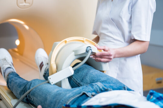 Radiologist prepares the patient for an MRI knee examination