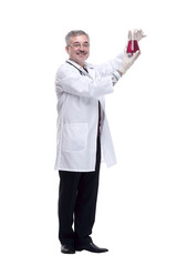 smiling doctor looking at the liquid in the flask