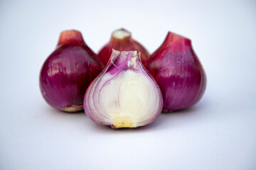 Red whole and sliced onions, isolated on white background