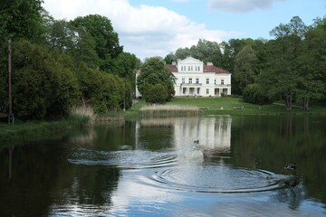 Obraz premium Raczynski Palace surrounded by a park with pond in the village of Zloty Potok in Krakowsko-Czestochowska Upland, Silesia, Poland