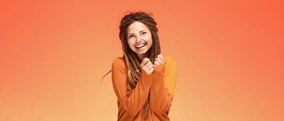 Funny laughing happy young woman with authentic hairstyle