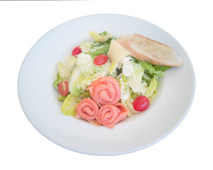 Salmon caesar salad with sour cream dressing, cheese, tomatoes on the white plate. Clipping path