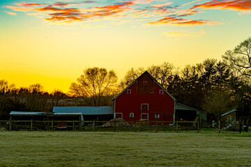 Sunset over rural landscape and barn