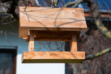 homemade wooden Birdhouse on a tree hanging from a strong branch