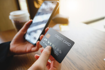 Online payment,Woman's hands holding a credit card and using smart phone for online shopping.