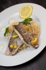 Lemon-spiked sea bream fillet, cooked wheat risotto on plate