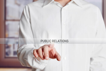Male hand presses public relations button on a virtual touch screen.