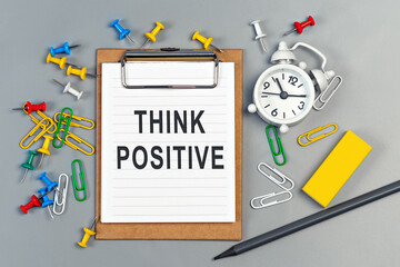 The words Think positive written on a white notebook. Work and study concept