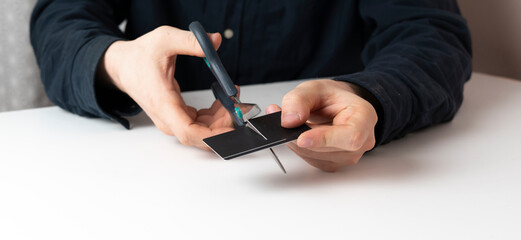 person cut the credit card with scissors. problem of bunkrupt and money loss