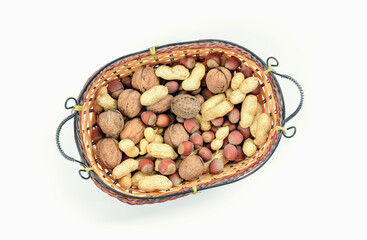 Blend of nuts in wicker basket on white background. The concept of proper nutrition.