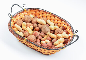 Blend of nuts in wicker basket on white background. The concept of proper nutrition.