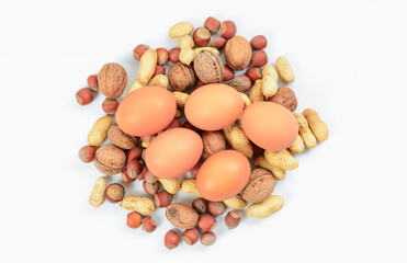 Blend of nuts with chicken eggs on white background. Concept of protein nutrition and diet for weight loss.