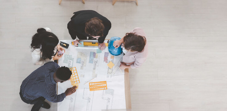 Teamwork brainstroming concept, Diversity engineer or architect group prople discussion on estate blueprint drawing with copy space top view