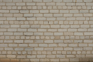 White brick wall. A little darkened with age. Texture. 