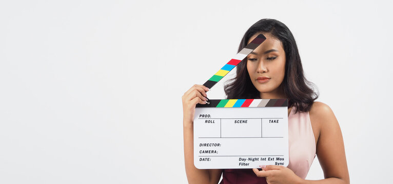 Asian sexy woman hold white clapper board or movie slate isolated on white background.She have tan skin ,show film,movies or cinema production concept.