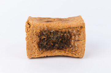 Meju front closeup on white background. Korean traditional fermented soybean food.