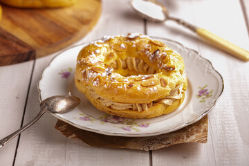 Small pastry Paris Brest in an old plate