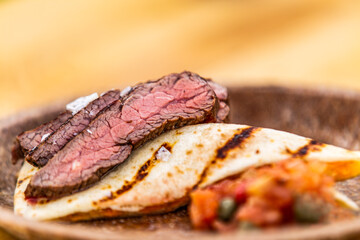 Flank steak with tortilla and vegetables. Food styling for street food. Closeup.