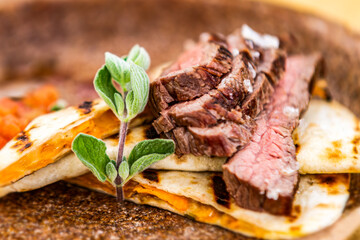 Flank steak with tortilla and vegetables. Food styling for street food. Closeup.