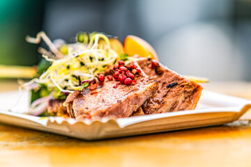 Pork ribs with grilled vegetables. Food styling for street food. Closeup.
