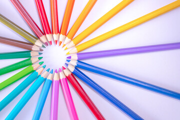 a row of colored pencils on a white background