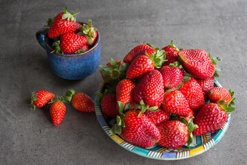 Fresh strawberry on grey table. Top view photo of juicy summer berries. 
