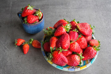 Fresh strawberry on grey table. Top view photo of juicy summer berries. 
